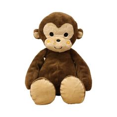 a brown stuffed monkey sitting up against a white background