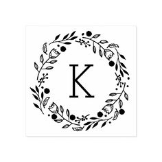 the letter k is surrounded by leaves and berries in a circle on a white background