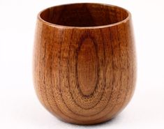 a wooden cup sitting on top of a white table