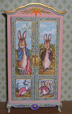 a pink cabinet with two rabbits painted on it