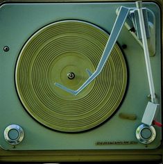 an old fashioned record player with the clock on it