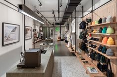 the inside of a shoe store with lots of shoes on shelves and pictures hanging from the ceiling