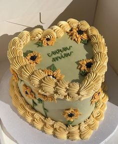 a sunflower decorated cake sitting on top of a white box with the words grandma written on it