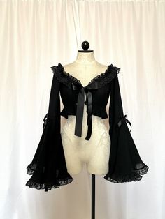 Stop the show and take a look at this beauty. Meet the Roselyn Top. She is a mystery and a blast. Roselyn is a crop top made with a gorgeous gauze stretch cotton, accompanied with a dramatic bell sleeved, Raschel ruffled lace trim, all tied together with a satin bow tie front.  iMPORTANT ♥️ Please contact us if you need or want an order by a certain time frame as our production and shipping times vary. We need to know in advance for orders with specific deadlines. Thank you! Bell Sleeve Bolero, Gothic Fitted Top With Sheer Sleeves, Fitted Gothic Top With Sheer Sleeves, Witchy Long Sleeve Party Tops, Witchy Long Sleeve Tops For Party, Gothic Cropped Top For Party, Elegant Cropped Tops With Sheer Sleeves, Evening Crop Top With Sheer Sleeves, Fall Crop Top With Sheer Sleeves