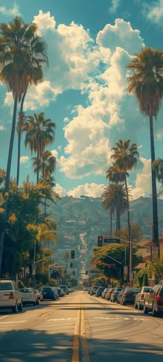 palm trees line the street as cars drive by on a sunny day with blue sky and white clouds