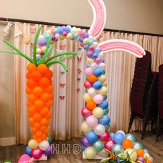 balloons and streamers are arranged in the shape of a carrot