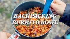 someone is holding a bowl full of food with the words backpacking burrito bowl