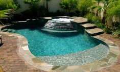 a pool with a fountain in the middle of it