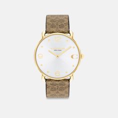 With clean lines and a modern minimalist sensibility the Elliot is a true design classic ready for workdays and weekends. Finished with a Signature canvas strap this gold tone round watch features a sunray dial detailed with our Signature marker at 3 o’clock. | Coach Elliot Watch, 36 Mm - Women's - Tan Coach Watches Women, Coach Watch, Round Watch, Signature Canvas, 3 O Clock, Minerals Crystals, Quartz Movement, Clean Lines, Modern Minimalist