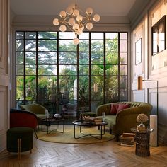 a living room filled with lots of furniture next to a large glass window covered in greenery