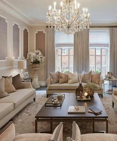 a living room filled with furniture and a chandelier