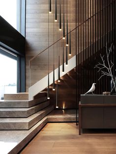 the stairs are made of wood and have decorative lights on them, along with a vase filled with flowers