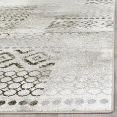 a white rug with black and grey designs on it