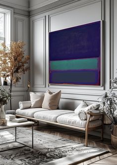 a living room filled with lots of furniture next to a large painting on the wall