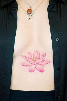 a woman's stomach with a pink flower tattoo on it