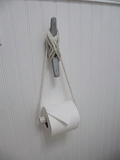 a roll of toilet paper hanging on the wall next to a towel dispenser