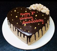 a heart shaped cake with chocolate frosting and sprinkles