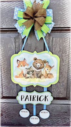 a door hanger with an image of two baby animals and the name patrick on it