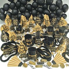 a bunch of black and gold items on a white table top with words written all over them