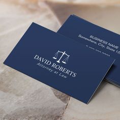 two business cards with an image of the scales of justice on them