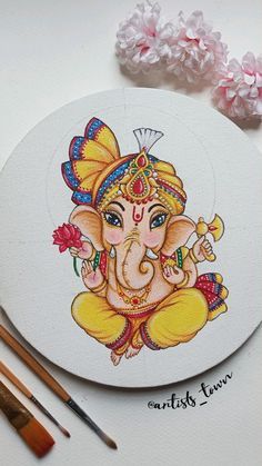 an elephant painted on top of a white plate next to paintbrushes and watercolors