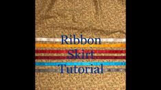 the words ribbon skirt are in blue, red, yellow and green letters on a tan background