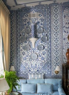 a living room with blue and white wallpaper