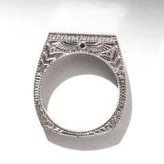 an intricately designed ring is shown against a white background