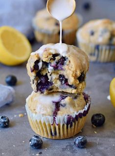 lemon blueberry muffins with icing being drizzled over them