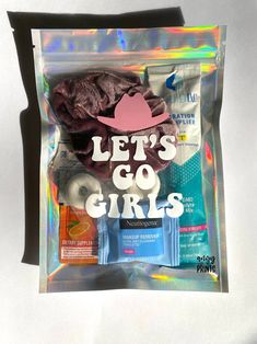 there is a bag that has some items in it and the words let's go girls on it