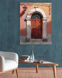 a painting on the wall of a room with a table and chair in front of it