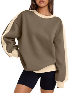 a woman wearing a brown and white sweater