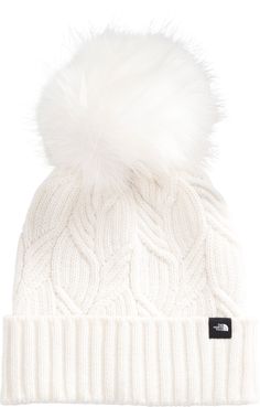 Fit and Design: Deep fit, one size beanie achieves a roomier, full-coverage fit Classic cable-knit texture helps keep you warm Wide cuff Extra-large faux fur pom The North Face® logo clip label on front of cuff Additional Details: Coordinates with The North Face® Oh-Mega Fur Pom Scarf Simple Winter Outfits, Von Maur, Winter Capsule, Winter Capsule Wardrobe, Beanie Style, Winter Cap, Wide Cuff, Pom Beanie, Fur Pom Pom