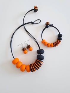 an orange and black necklace with matching earrings