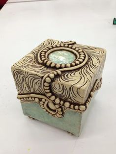 an intricately carved box sitting on top of a table