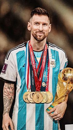 the soccer player is holding his trophy and posing for a photo with it's medal