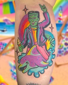 a person with a colorful tattoo on their leg