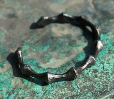 Hand forged bracelet in a bio-industrial style. This one is similar to the limb of a spider. Patina is made from the oak's bark, treated against rust. In a last step of your order send us a circumference of your wrist. Forged Bracelet, Viking Accessories, Viking Arm Rings, Arm Ring, Celtic Viking, Nordic Vikings, Real Steel, Forged Steel, Blacksmithing