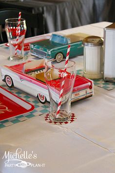 a table with cars and drinks on it