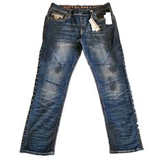 Rock Revival Slim Straight Lampson Biker K201 Men's 40x33 Embroidered Studded Step up your style game with these Rock Revival Biker Moto jeans. These dark blue jeans are made of a cotton blend with a touch of spandex for added stretch and comfort. The 5-pocket design includes accents like studded, double stitch, and embroidered details to give these jeans a unique and edgy look. With a zip fly and a waist size of 40 inches, these jeans have a regular fit and a straight style with a mid-rise. The denim fabric wash is dark and the inseam measures at 32 inches. Don't miss out on these statement jeans that are perfect for any casual occasion. Size info True to size. Details & care Cut from stretch denim, these moto jeans keep you looking sharp and feeling comfortable from day to night. 99% cot Statement Jeans, Jeans Embroidered, Moto Jeans, Double Stitch, Dark Blue Jeans, Embroidered Details, Slim Straight Jeans, Edgy Look, Rock Revival