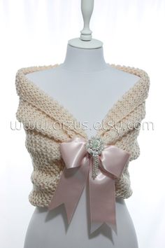 a white mannequin with a pink bow on it's chest and back