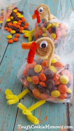 two turkeys made out of candy in plastic bags on a table with candy candies