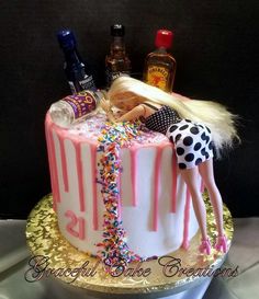 a barbie doll is laying on top of a birthday cake with confetti and sprinkles