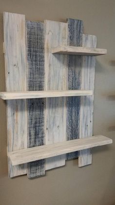 some shelves made out of pallet wood are hanging on the wall in this room