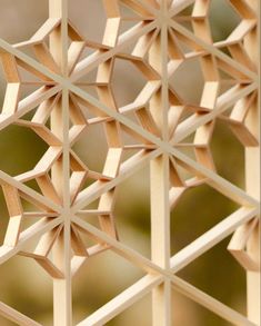 a close up view of a wooden structure made out of wood sticks and paper strips