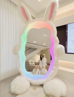 a woman is standing in front of a mirror with bunny ears on it