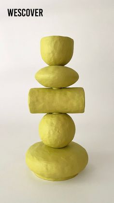 a stack of rocks sitting on top of each other in front of a white background