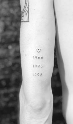 a person with a tattoo on their arm that reads, 1960 - 1989 written in white ink