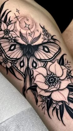 a black and white butterfly with flowers on it's thigh, next to the word hystgramm