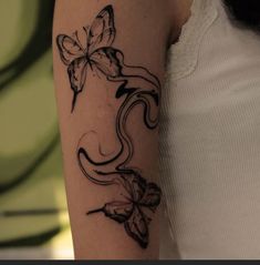 a woman with a butterfly tattoo on her arm